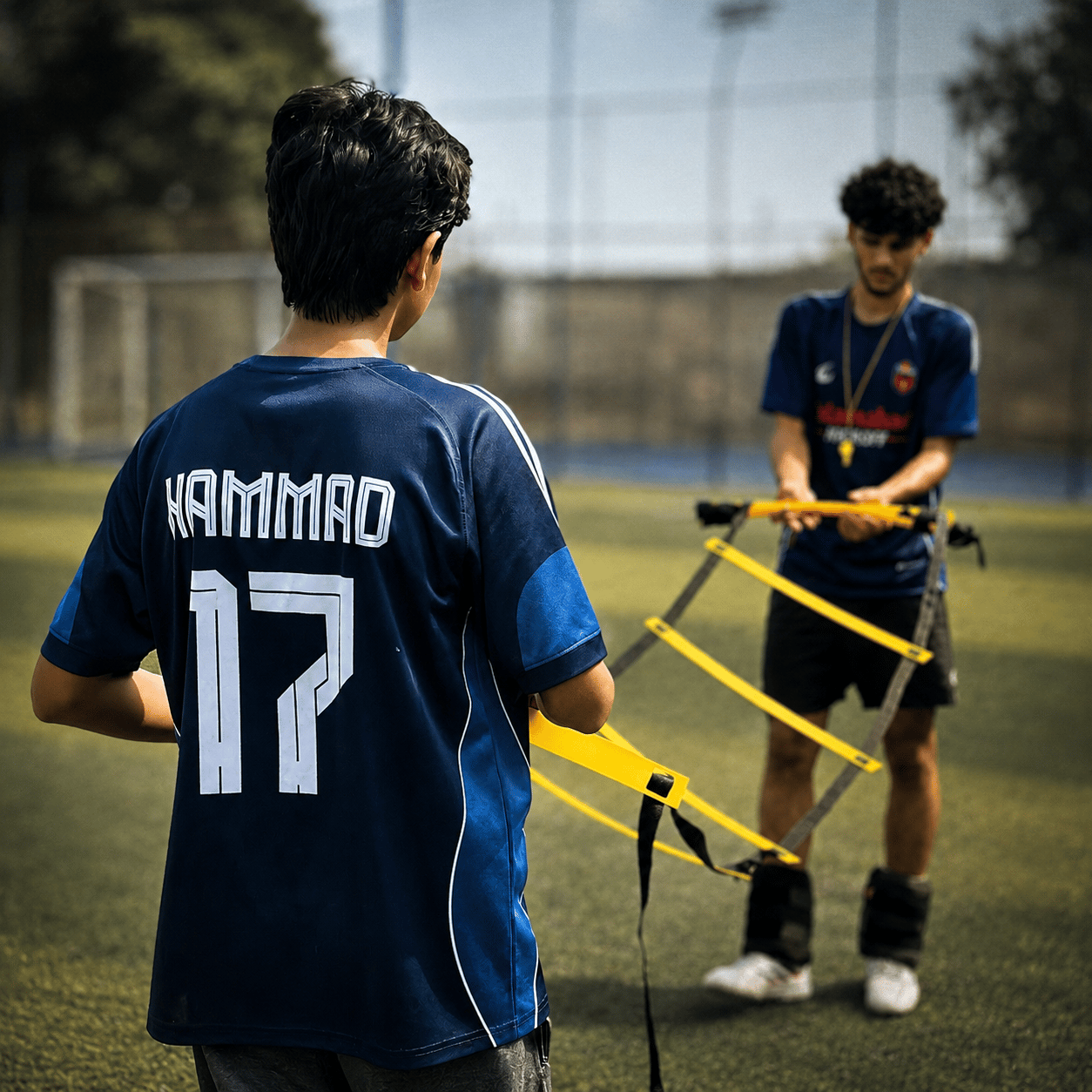 A coach running a TWA FC player through an agility ladder drill