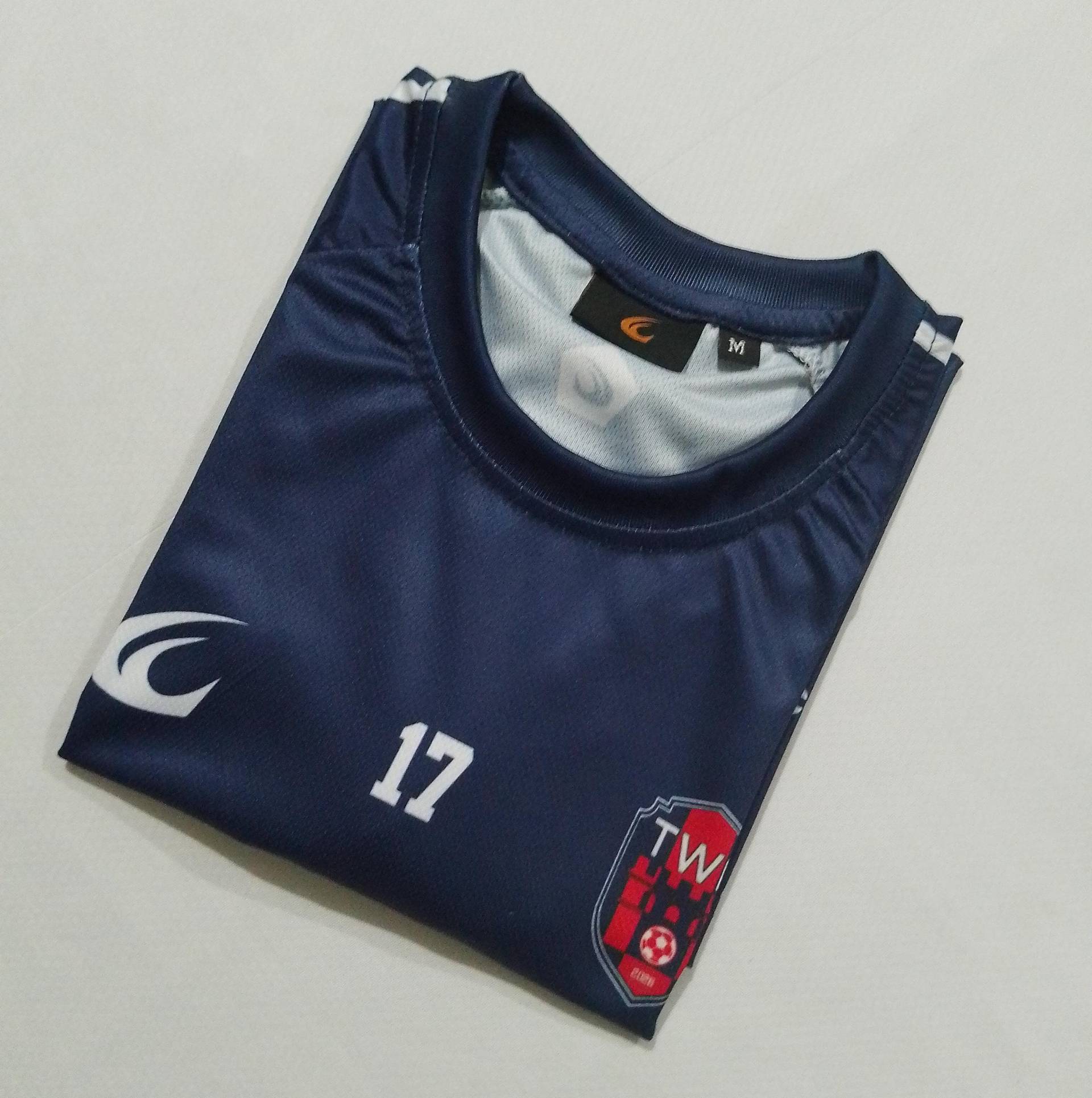 The back of the navy home shirt, folded, showing the number 17